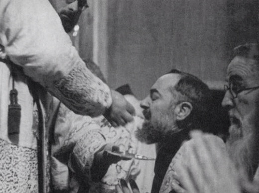 Padre Pio kneeling